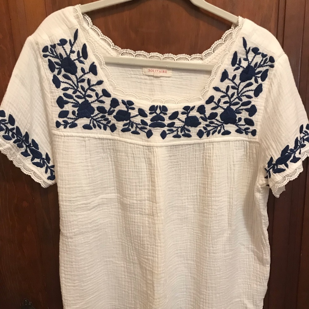 Solitaire brand embroidered top.
